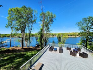 A deck with outdoor furniture overlooking a lake. - New Listing! Perfect Lake Bowen Home With Lake Views, Decks, & Dock (Inman)