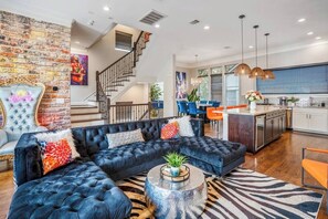 A modern living room with a sectional sofa, a round coffee table, and a zebra-patterned rug.