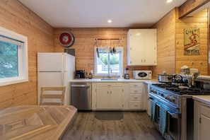 Enjoy cooking in this kitchen with a gas stove, microwave, and stainless steel appliances.