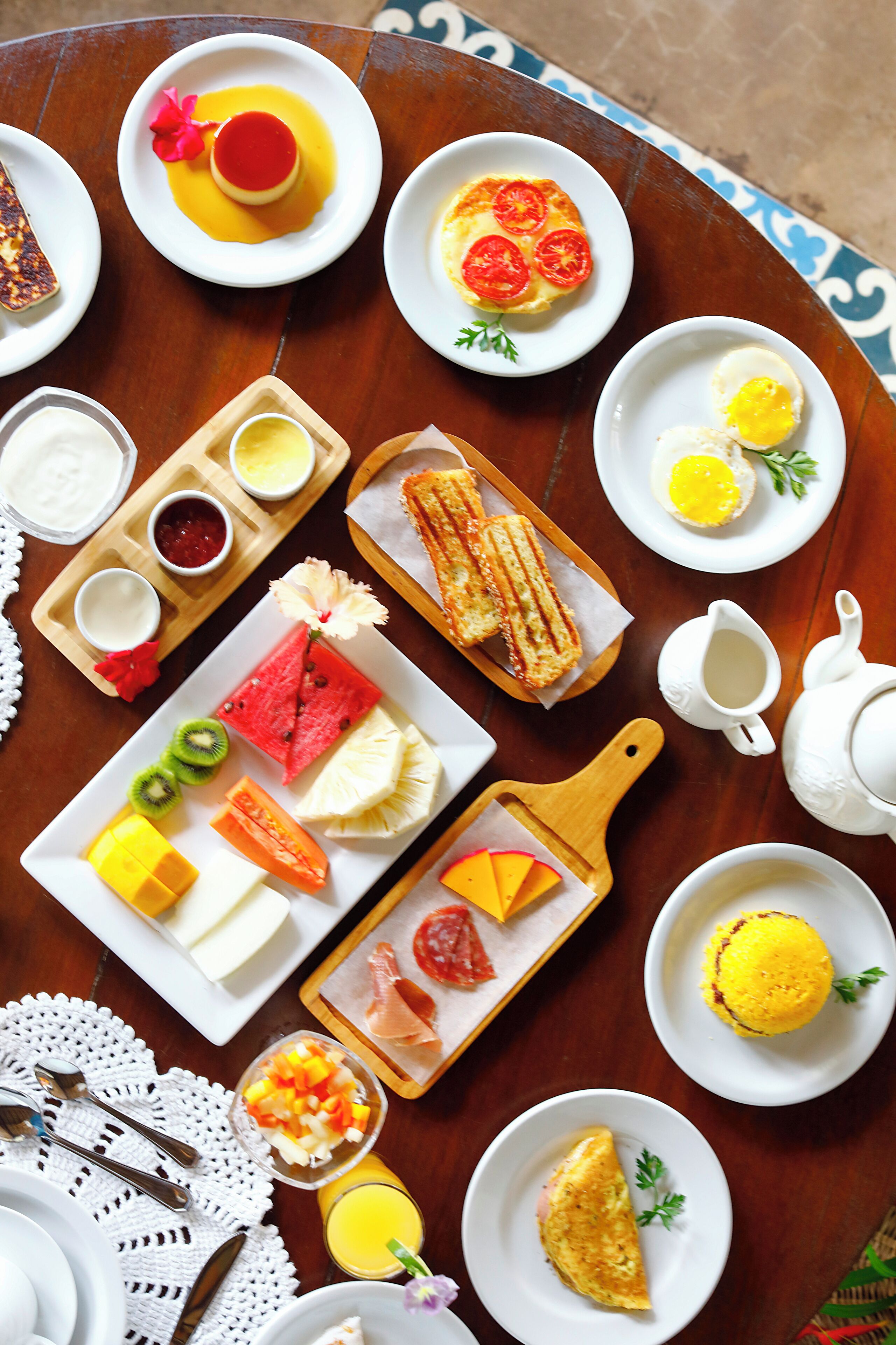 Ein Tisch mit verschiedenen Frühstücksangeboten, darunter Toast, Eier und Obst.