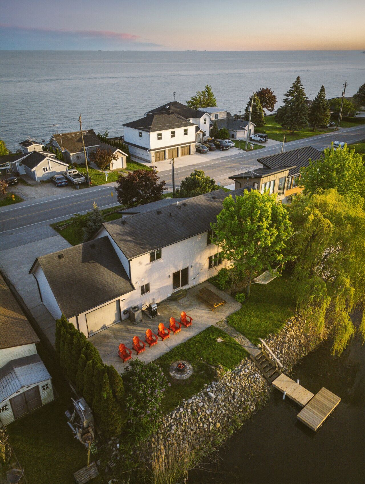 A residential area with houses, a dock, and a view of the water.