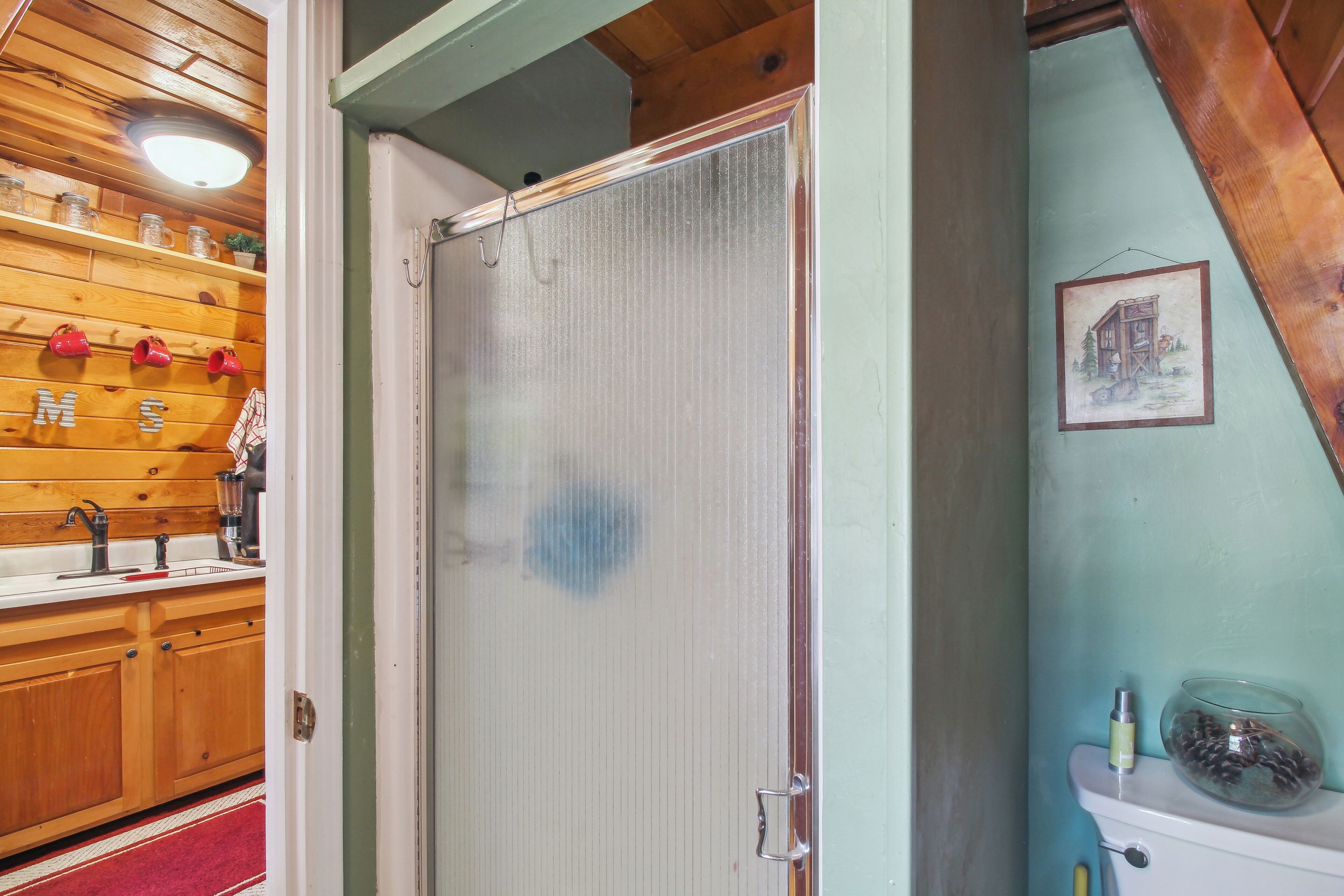 A kitchen with wooden cabinets, a red towel, and a sink.