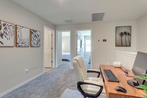 Work in comfort with a desk and chair, plus a beautiful wall art piece.