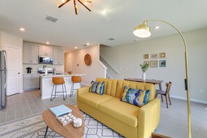 Relax in this inviting living space with a sofa, coffee table, and dining area.