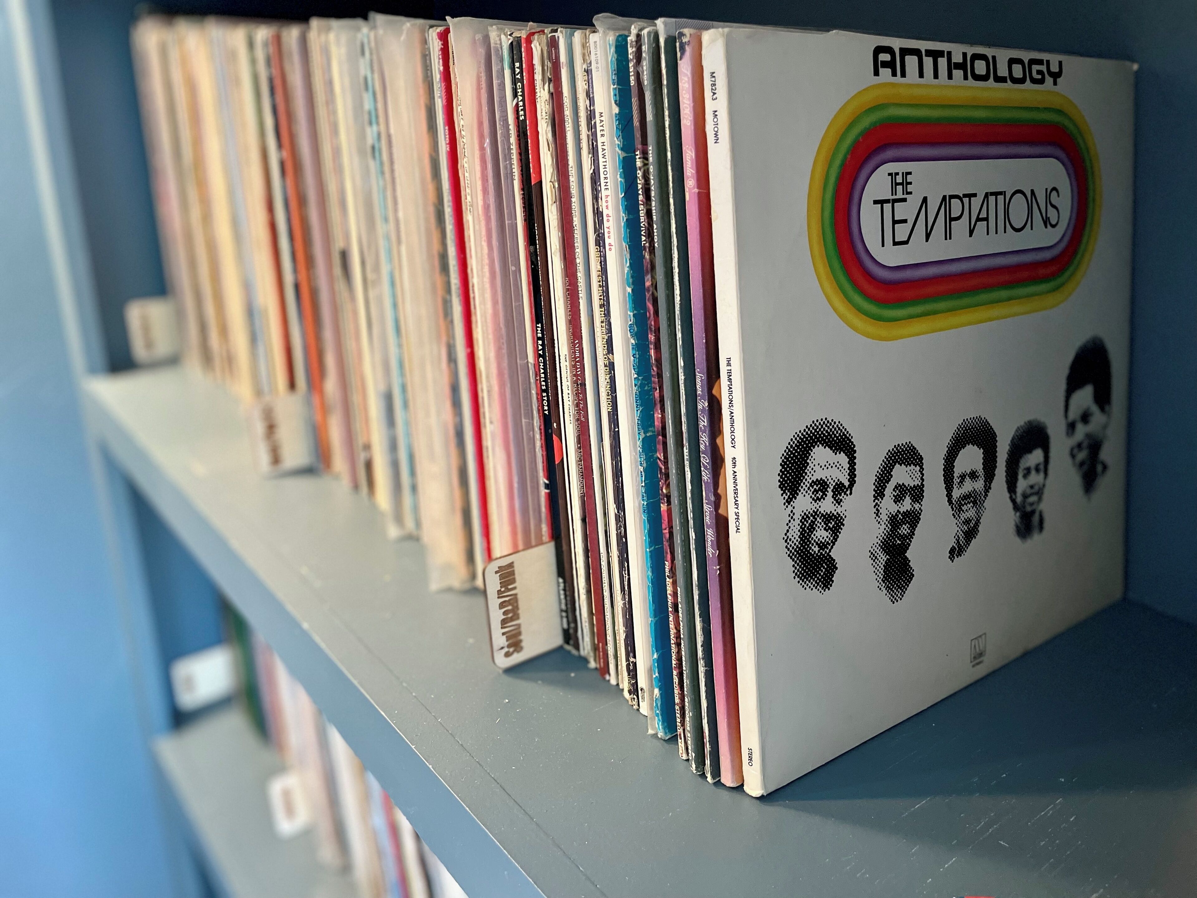 A shelf with a collection of vinyl records.