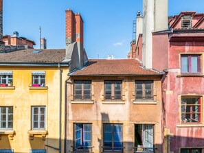 A row of colorful buildings with multiple windows and balconies, typical of a historic urban area.