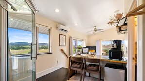 A kitchen with a dining table, chairs, a refrigerator, and a coffee maker. - Be Suite Vineyard Retreat (Paso Robles)
