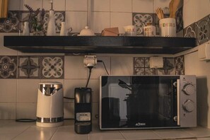 Fridge, stovetop, electric kettle, cookware/dishes/utensils