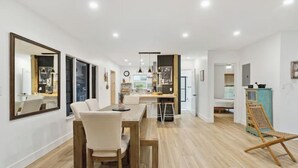 A modern interior with a dining area, kitchen, and a living space. - Charming Farmhouse style w/cowboy pool in Fort Lauderdale (Fort Lauderdale)