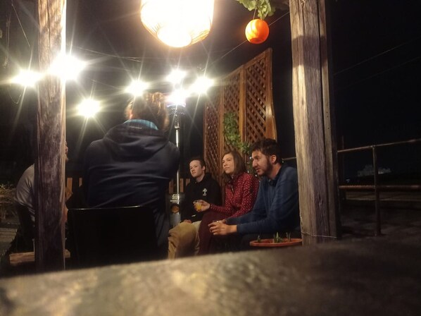 A group of people seated around a table with a microphone, suggesting a meeting or interview setting. - Puruha Inn (Riobamba)