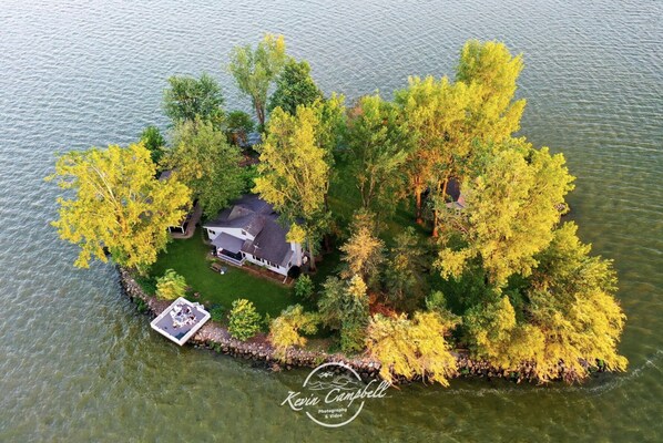 An aerial view of a house surrounded by trees on a lake. - Private Island! Includes 2 houses, covered boathouse, best sunset on Indian Lake (Washington Township)