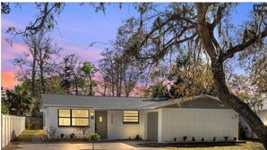 A single-story house with a garage, a front porch, and a small front yard. - Unleash the Fun: Pool Table, Fishing Poles, and Ping Pong Table, Smoker (Port Orange)