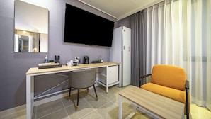 A hotel room with a desk, chair, TV, and a sofa. - Browndot Angang (Gyeongju)