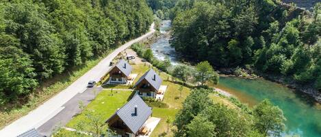 A lodge with multiple cabins, a road, and a river.