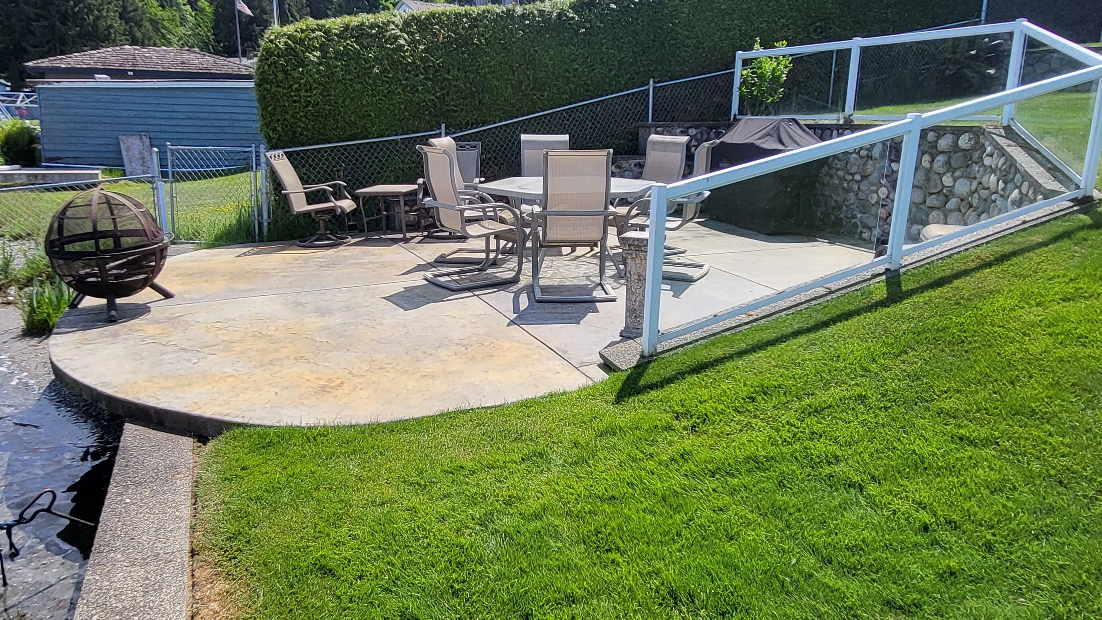 A patio with outdoor furniture, a round table, and a seating area.