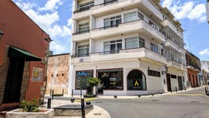 A multi-story building with a ground-floor restaurant and a second-floor commercial space.