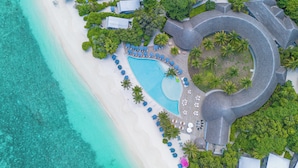 An aerial view of a resort with a large pool, beach, and palm trees. -  Ifuru Island Maldives  (Ifuru)