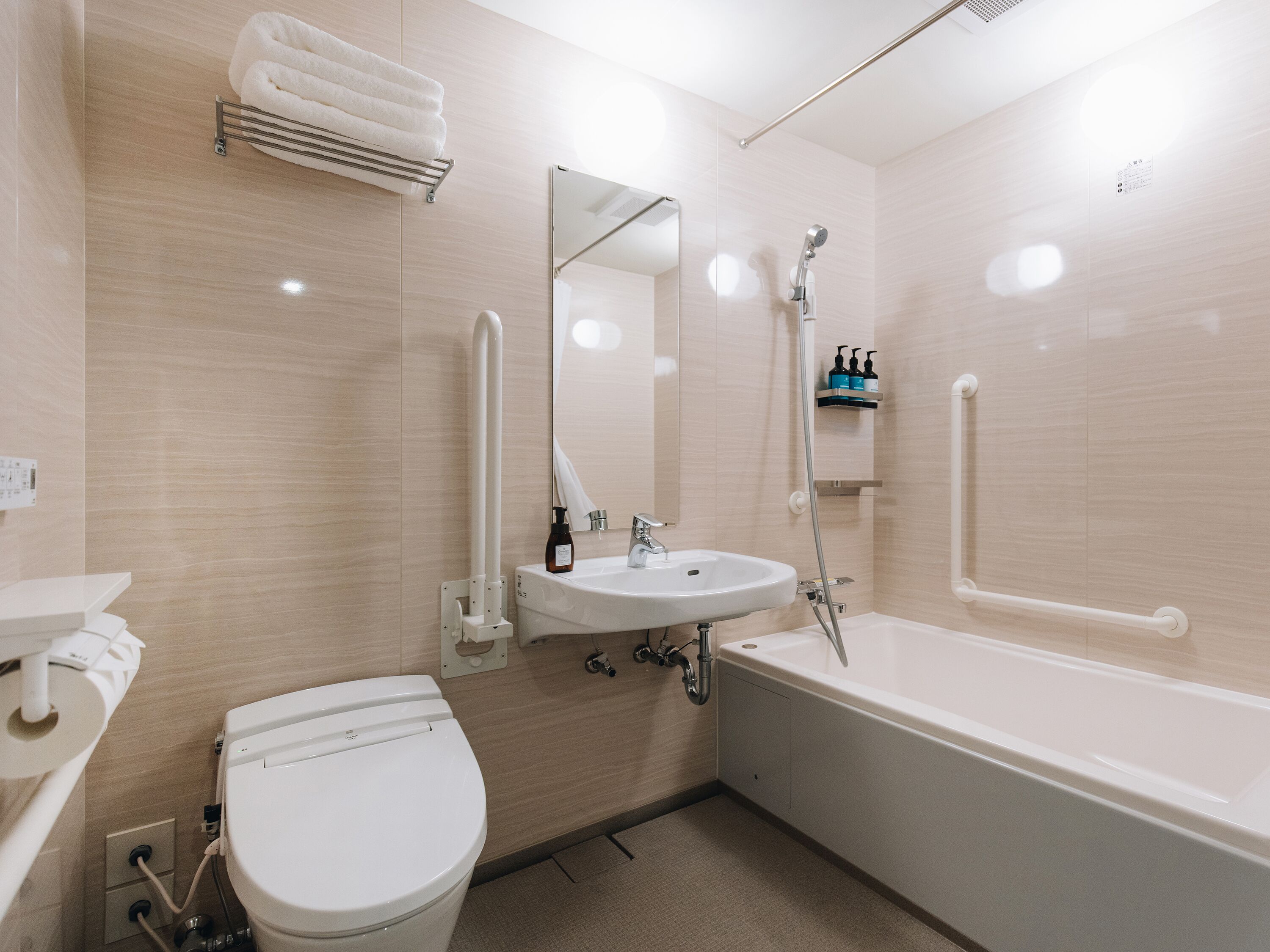 A modern bathroom with a toilet, sink, and bathtub.