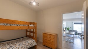 A room with a bunk bed, a wooden dresser, and a desk with a chair. - Apartment "Gîte les Monteils" with Mountain View, Private Terrace & A/C (Vesseaux)