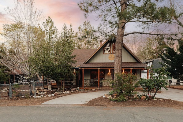 A lodge with a stone facade, wooden beams, and a covered porch.
