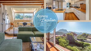 Un apartamento moderno con una zona de estar acogedora, una cocina con pared de piedra y vistas panorámicas del pueblo.