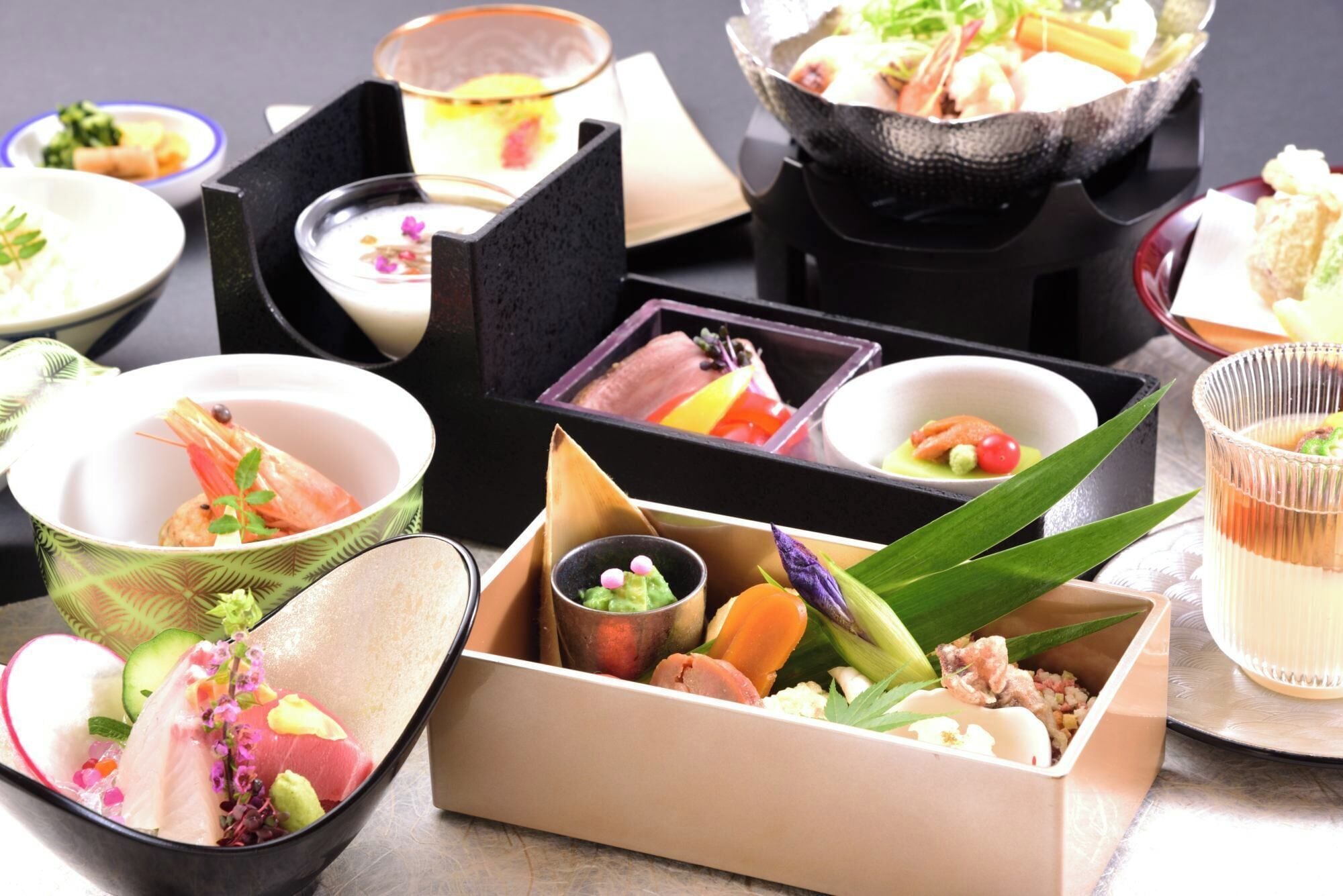 A variety of dishes arranged in different bowls and containers, suggesting a meal setting.