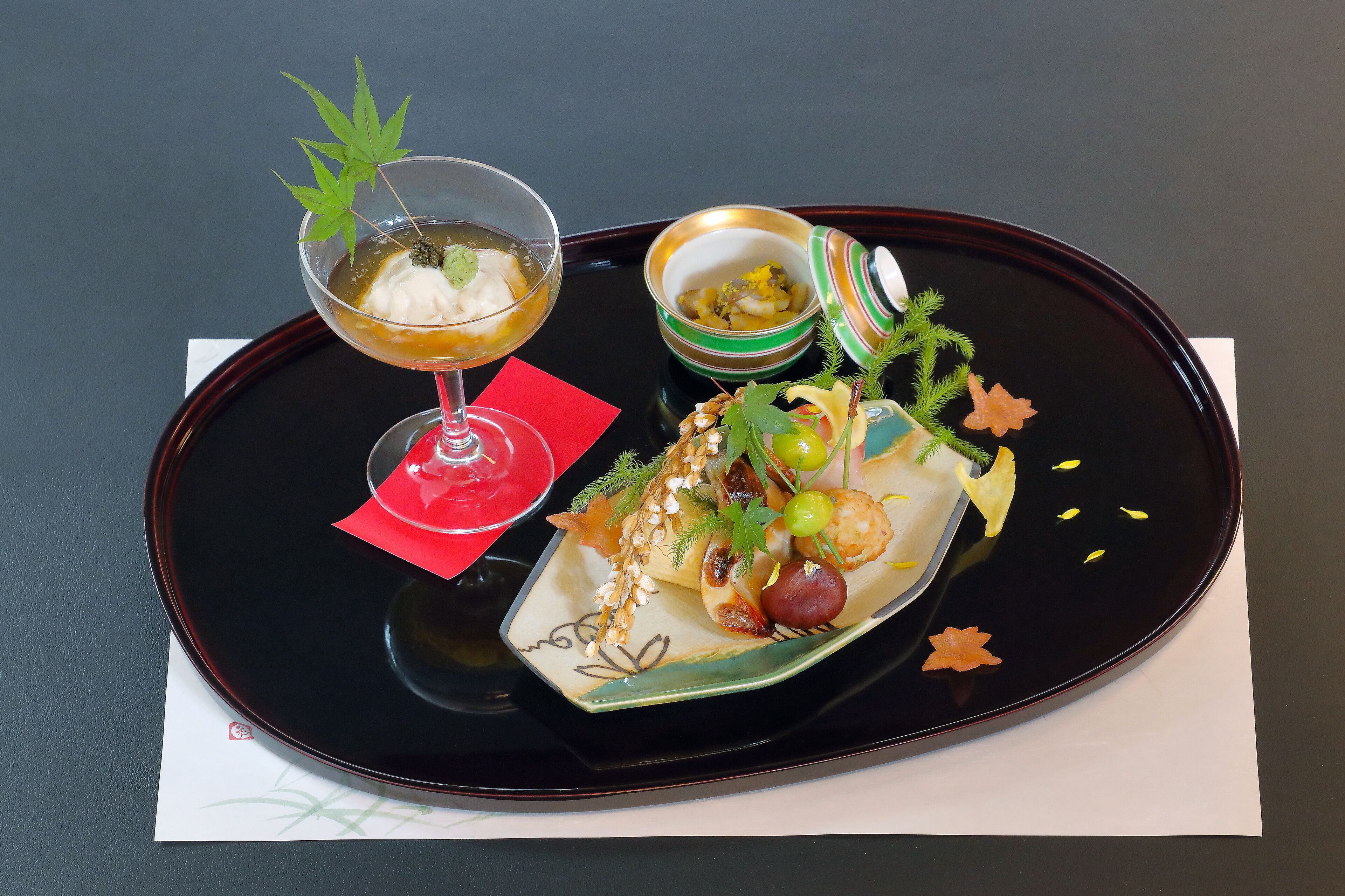 A tray with a dessert, a drink, and a small bowl of food.