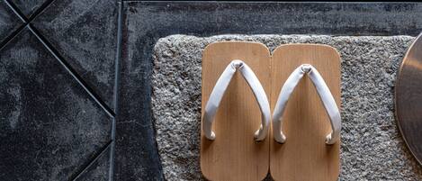 A pair of flip-flops on a textured mat.