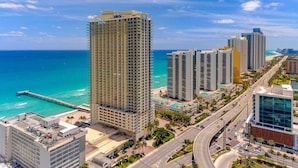 A high-rise hotel with multiple floors, a beach view, and a road with vehicles. - High Floor - Unbelievable Ocean Views - 39th floor 3 Bedroom on the Beach! WOW (Sunny Isles Beach)
