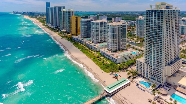 A coastal high-rise hotel with multiple buildings, a beach, and a pier. - High Floor - Unbelievable Ocean Views - 39th floor 3 Bedroom on the Beach! WOW (Sunny Isles Beach)