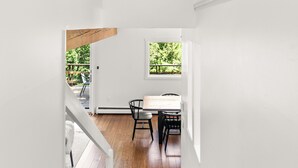 A staircase leading to a dining area with a view of the outdoors. - The Overlook - Hot Tub, Game Room, 5min to MTN (Killington)