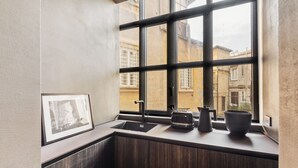 A modern kitchen with a large window, a sink, a toaster, and a kettle. - Charm and Style by The Spanish Steps (Roma)