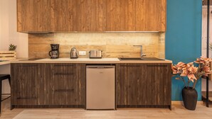 A modern kitchen with wooden cabinets, a dishwasher, and a sink. - Semiso Beach Suite 9 (rethymno)