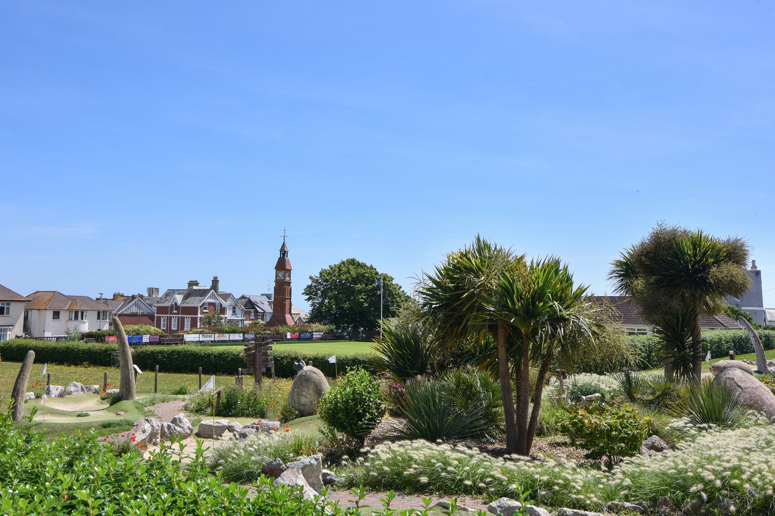 A golf course with a clock tower in the background.