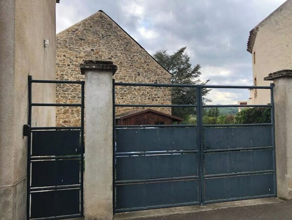 A stone building with a metal gate.