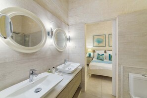 A modern bathroom with two sinks, a mirror, and a shower. - Palm Grove by Bluescape (Mullins)