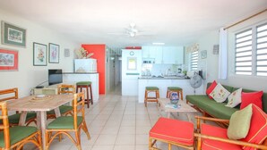 A compact living space with a dining area, kitchen, and seating area. - 3 Sea Star by BSL Rentals (Worthing)