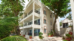 A multi-story building with balconies, potted plants, and a pathway. - 3 Sea Star by BSL Rentals (Worthing)