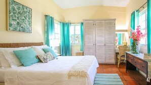 A bedroom with a bed, a wardrobe, a desk, and a chair. - Aqua Bliss 3 Bedroom Home by Bluescape (Holetown)