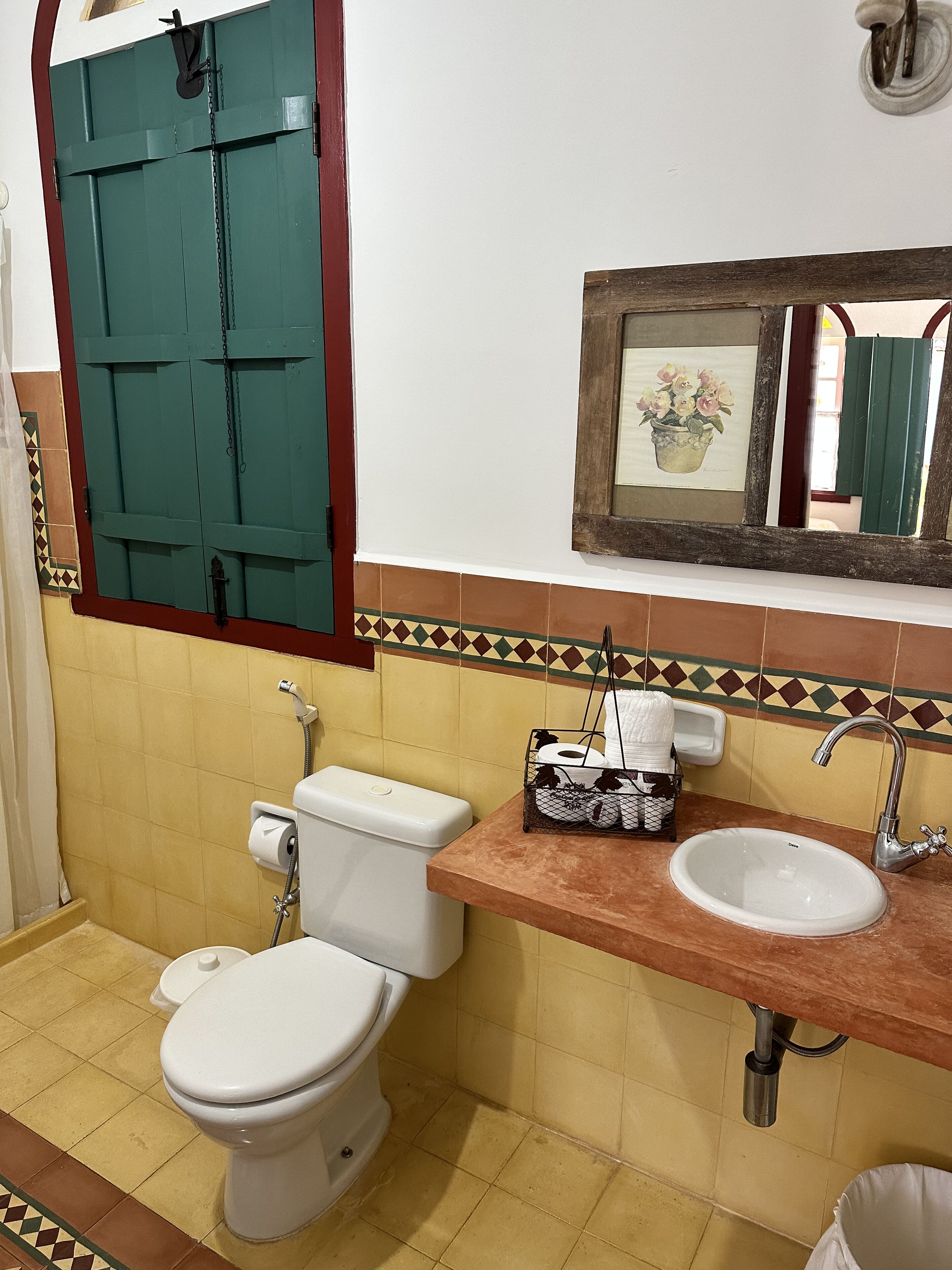 Une salle de bain avec des toilettes, un lavabo et une douche.