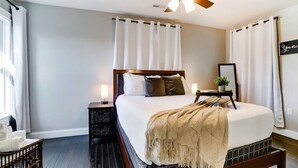 A neatly arranged bedroom with a bed, bedside tables, a nightstand, a ceiling fan, and a window with curtains. - Spacious 4BR/3.5BA Home Near UD, Oregon &DT Dayton (Dayton)