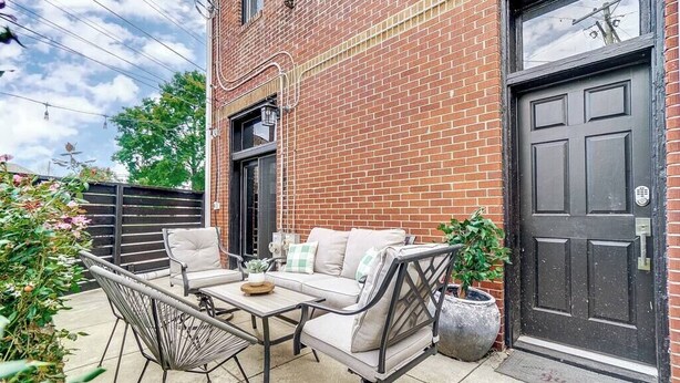 A patio with outdoor furniture, a brick building, and a black door. - Dayton Loft close to DT, Oregon, UD (Dayton)
