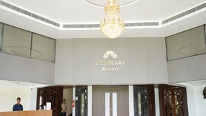 A spacious lobby with a chandelier, a reception desk, and a sign for Mulberry Resort. - Bamboo Saa Mulberry Resort Pushkar (Pushkar)