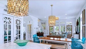 A spacious kitchen with a marble countertop, a wooden dining table, and blue chairs. - Stunning views of Lake Blackshear! (Warwick)