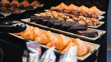 Une grande variété de viennoiseries et de desserts sont présentés, notamment des croissants et des brownies.
