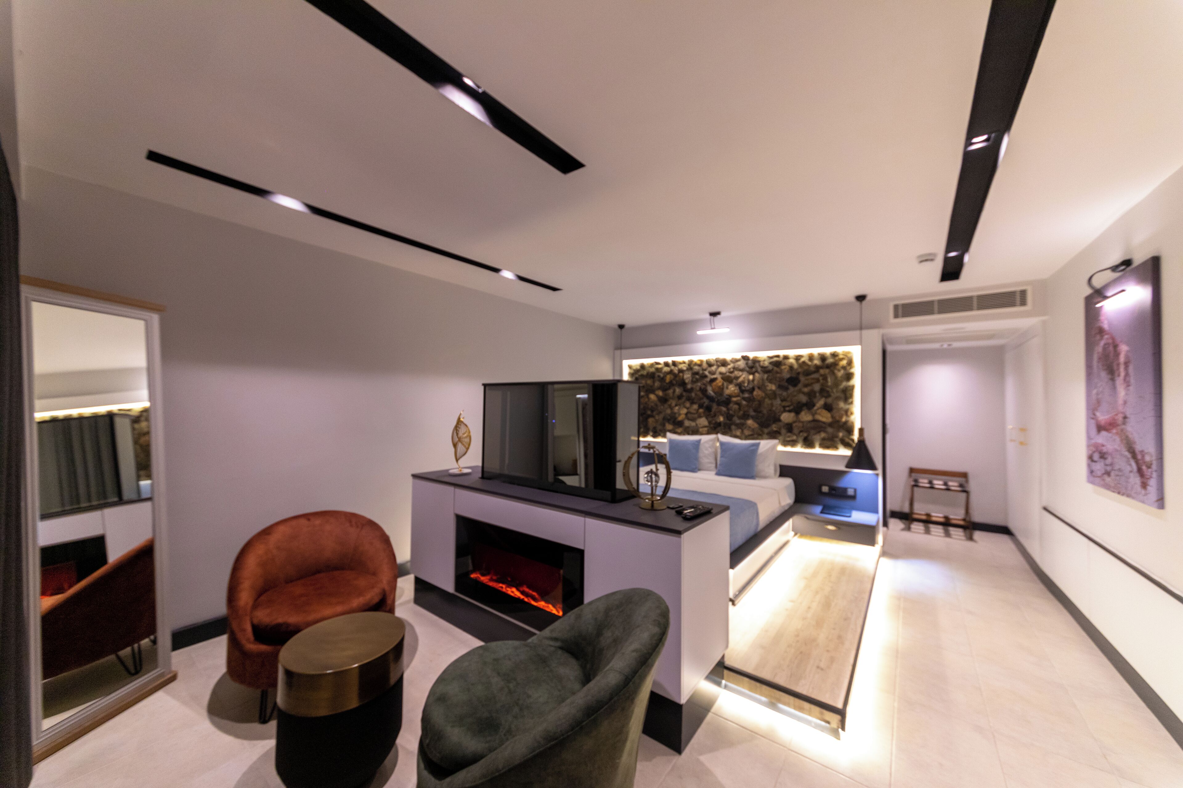 A modern living room with a fireplace, a sofa, and a television.