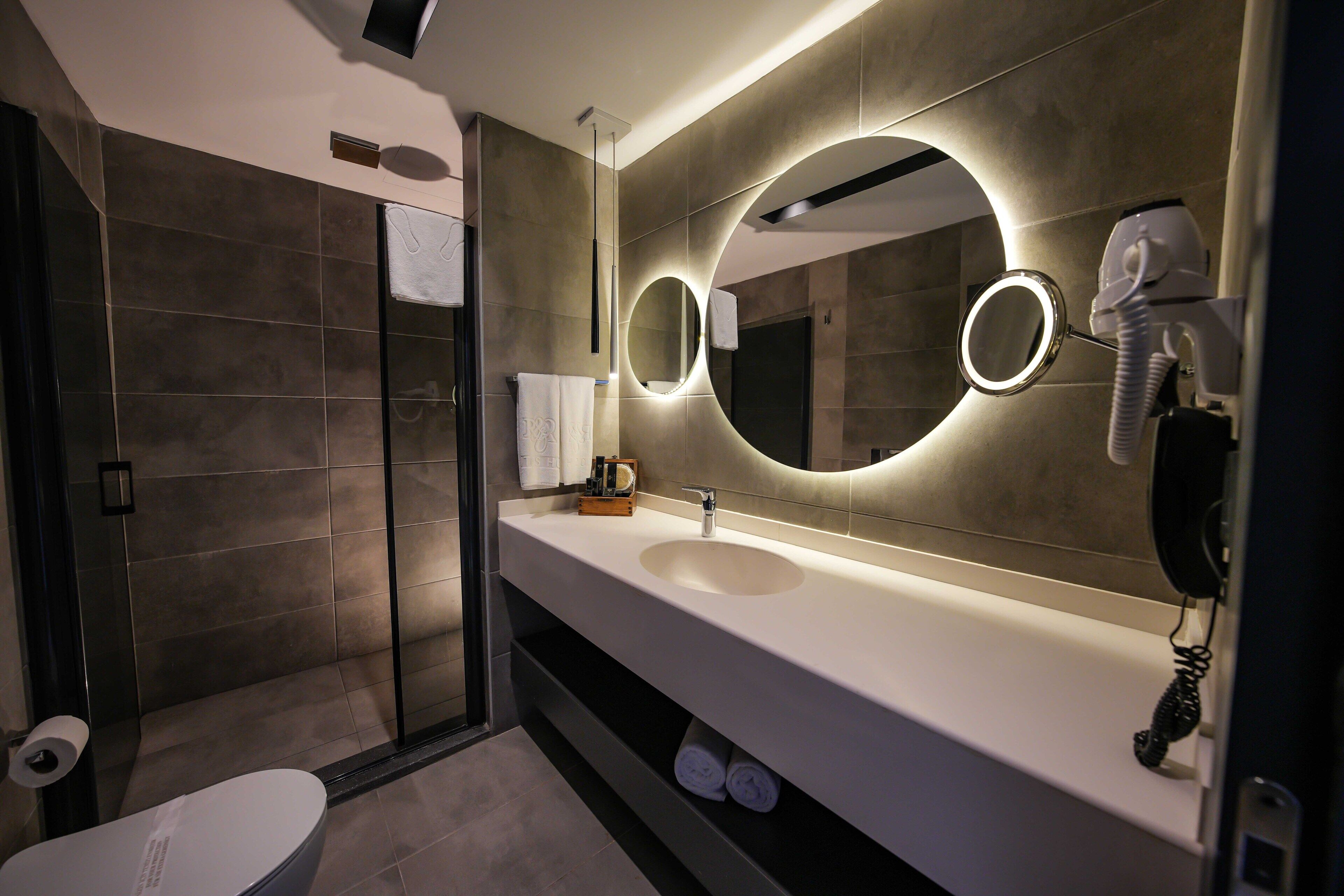 Shower, designer toiletries, hair dryer, slippers