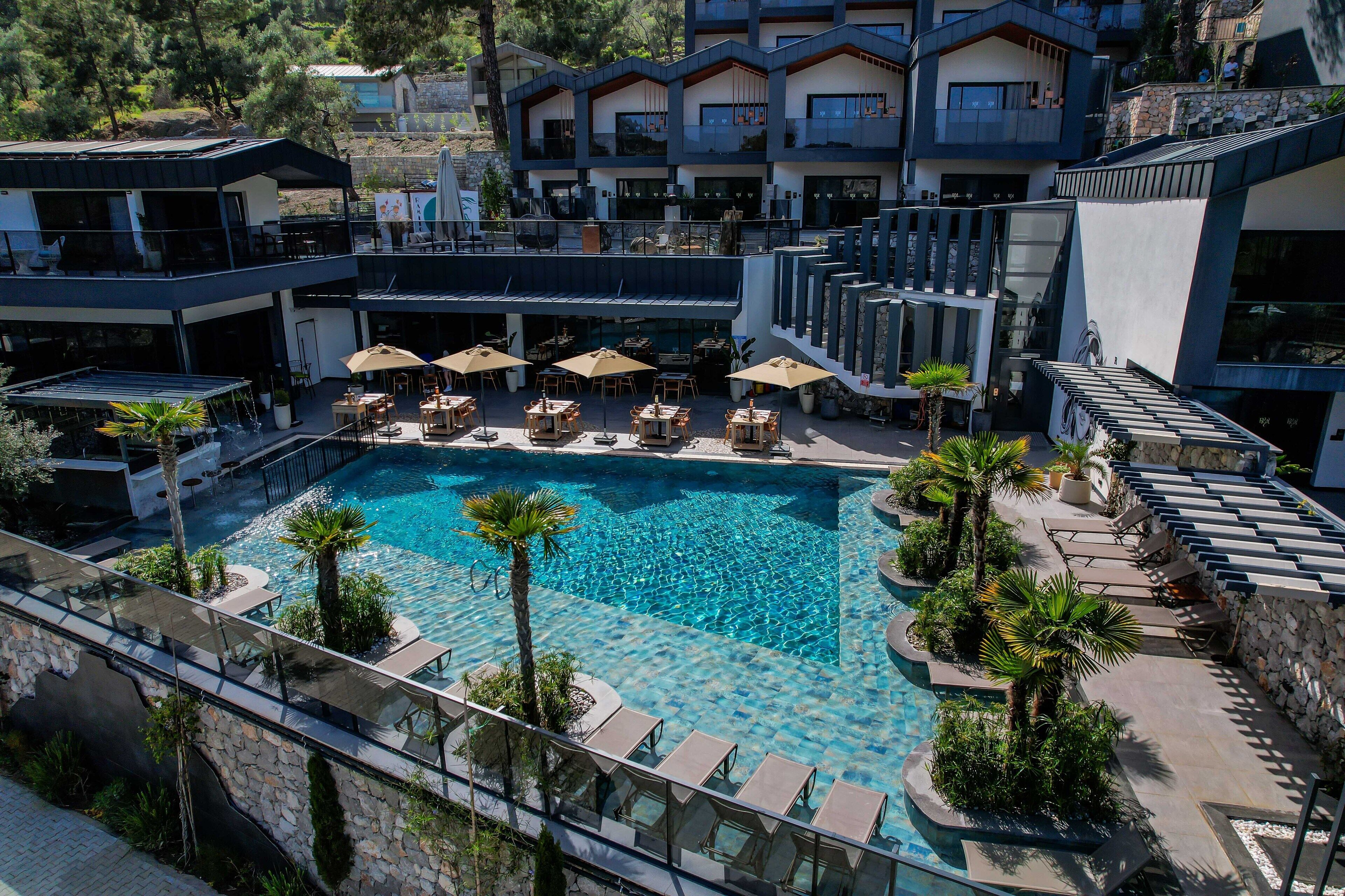 Resort com piscina, área de estar externa e vários edifícios.