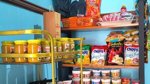 A snack and condiment display in a store with various products like chips, crackers, and sauces. - Yellow Pad Hotel Davao (Davao)