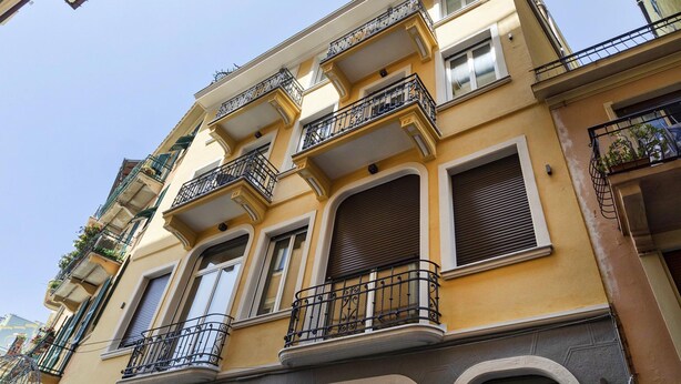 Un immeuble à plusieurs étages doté de balcons, de grandes fenêtres et d’un style architectural classique.